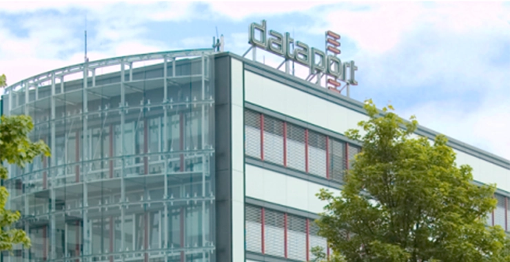 Building with “Dataport” lettering under clear skies, two trees in the foreground (Dataport).