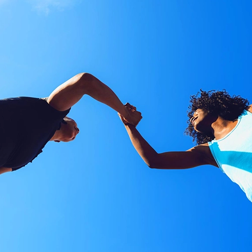 Man and woman in sportswear against a blue background.
